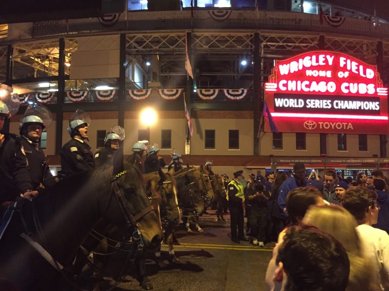 Cubs fans celebrate by wrecking cars near Wrigley Field after Chicago wins World Series