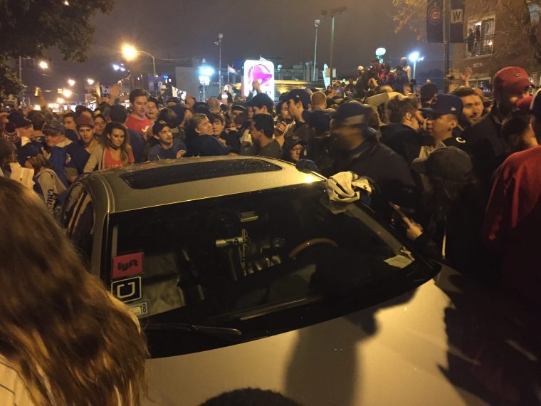 Cubs fans celebrate by wrecking cars near Wrigley Field after Chicago wins World Series