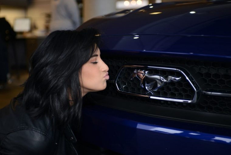 American Idol contestant Jena Irena kisses the Ford Mustang’s grille