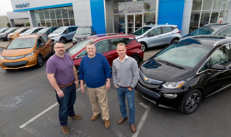 The first three 2017 Chevy Bolt EV customers in California pose with electric vehicle