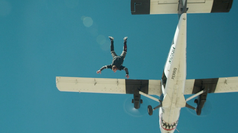 Jeremy Renner jumping out of a plane