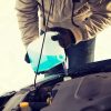 man pouring anti freeze engine gasoline freeze cold winter chill temperatures car