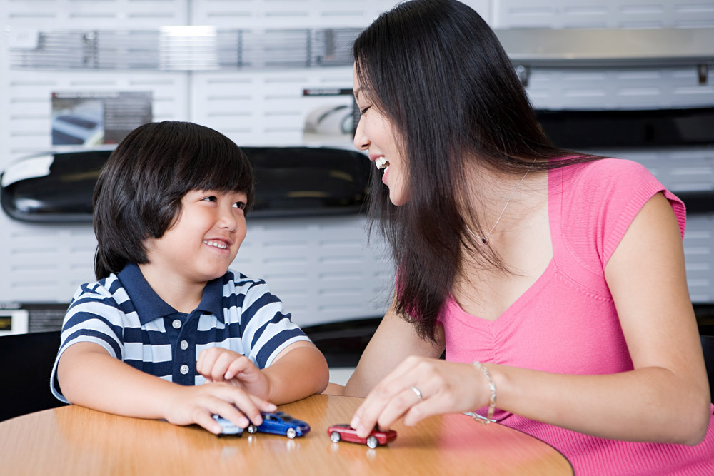 Mom and kid playing with toy cars