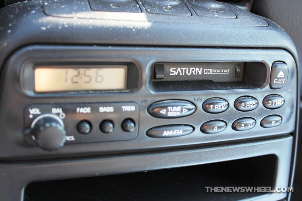 Old cassette radio system in the dashboard of a vintage Saturn Coupe