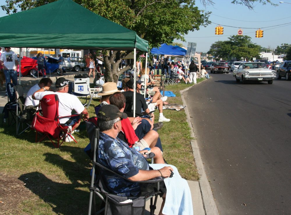 Spectators near street watching cars at Woodward Dream Cruise in Detroit