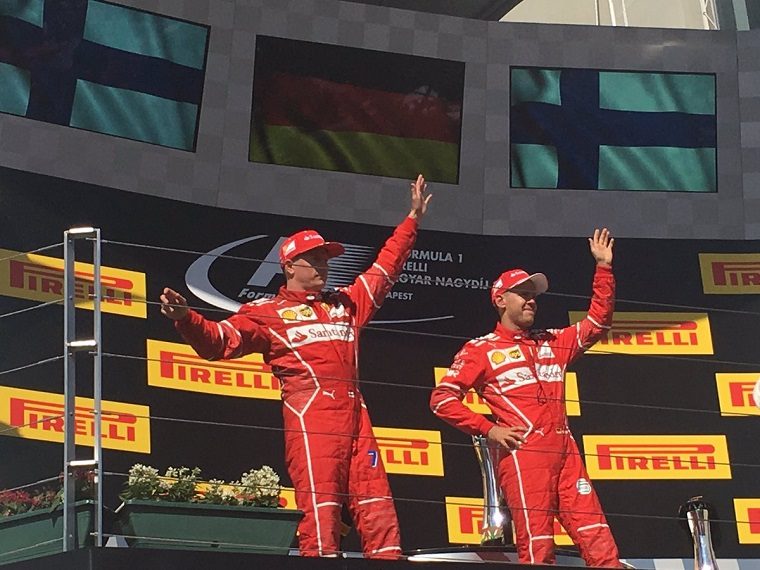 Raikkonen and Vettel wave on the podium