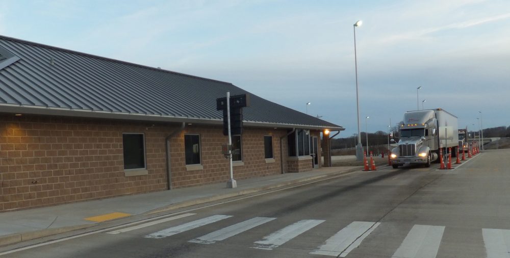 truck entering a highway weigh station off the interstate