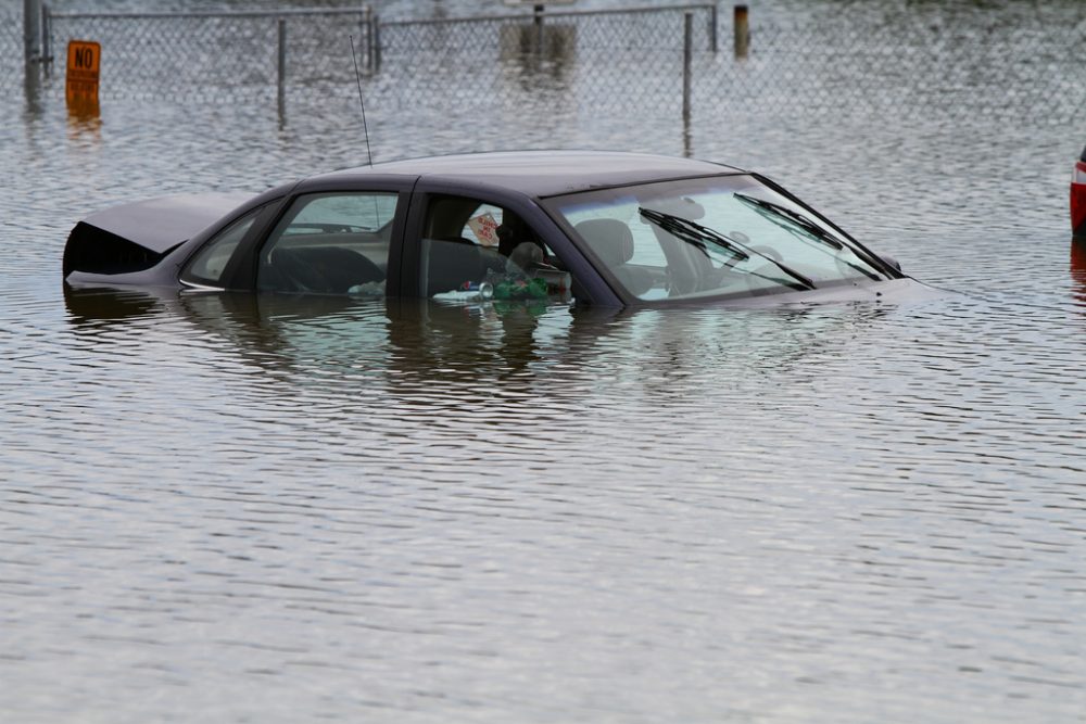 car trapped on flooded road