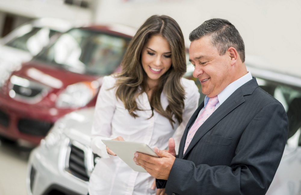 Man and Woman at a Car Dealership