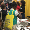 Patrice Banks showing girls around the engine of a car at G.I.R.L. 2017