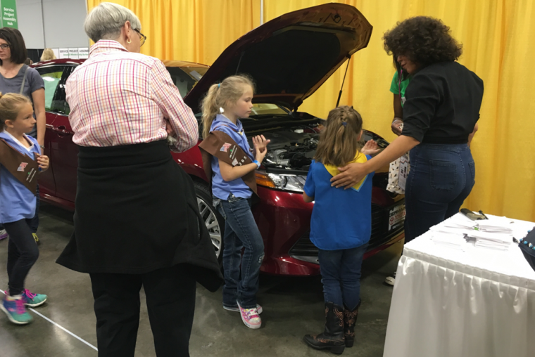 Patrice Banks showing girls around the engine of a car at G.I.R.L. 2017