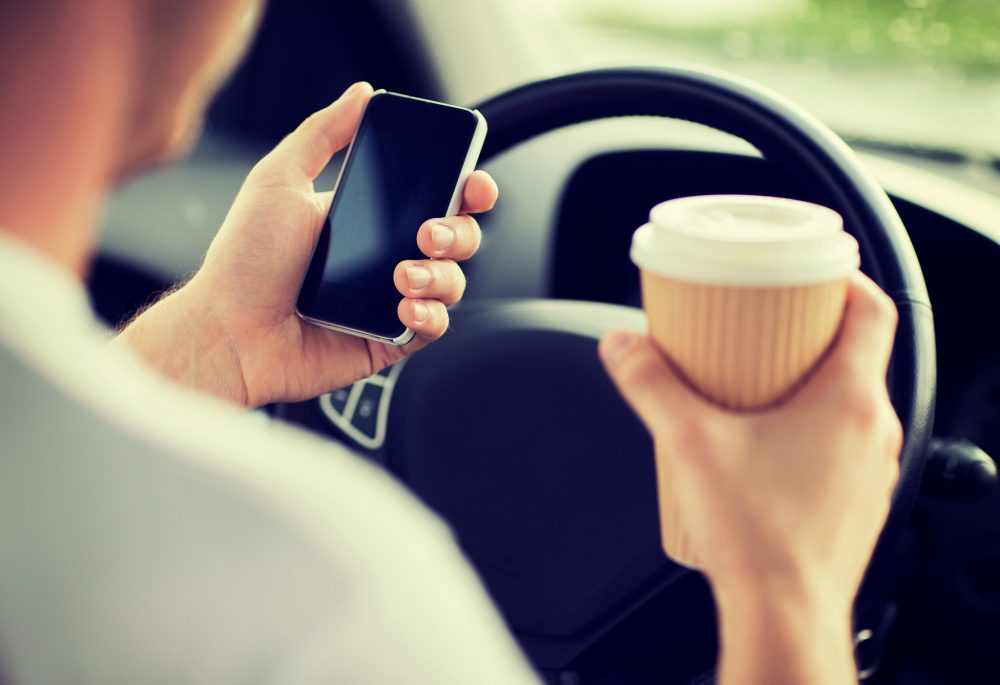 man using cell phone while driving