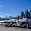 Parked motorhomes near trees and mountains