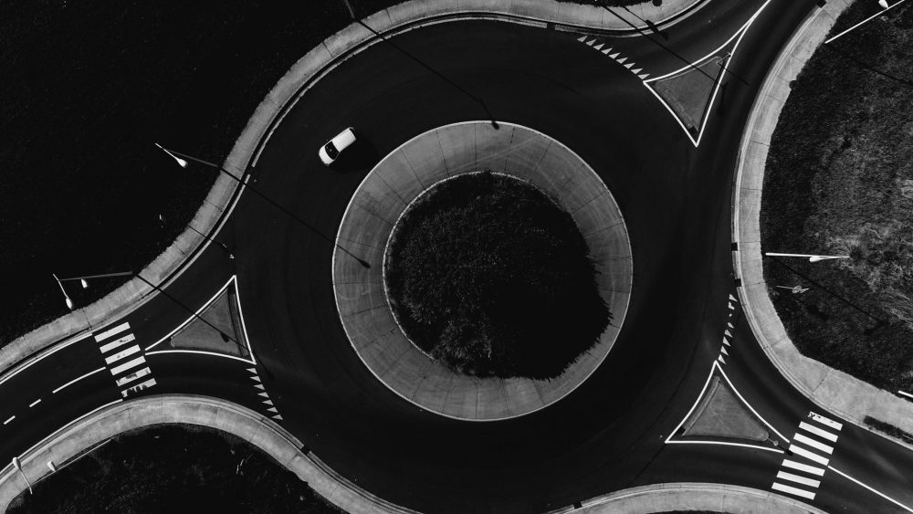 Aerial photo of a roundabout with one car driving around it