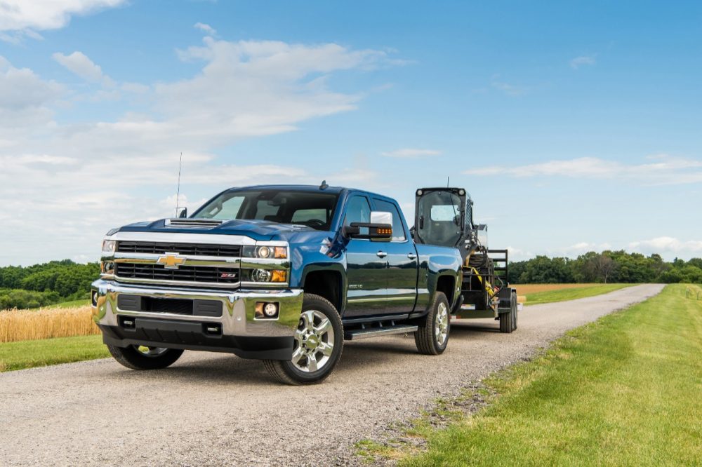 2018 Silverado 2500 HD Deep Ocean Blue Metallic LTZ Z71 Crew Cab towing John Deere Skid Steer with a Big Tex Trailer. Towing 10,808 pounds (total weight of trailer and equipment combined).