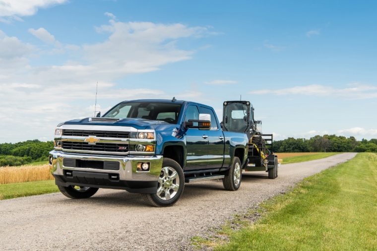 2018 Silverado 2500 HD Deep Ocean Blue Metallic LTZ Z71 Crew Cab towing John Deere Skid Steer with a Big Tex Trailer. Towing 10,808 pounds (total weight of trailer and equipment combined).