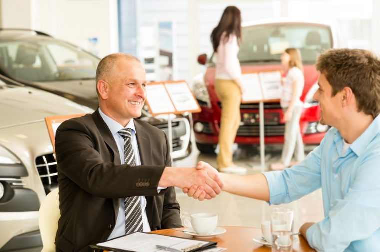 business deal handshake car sales