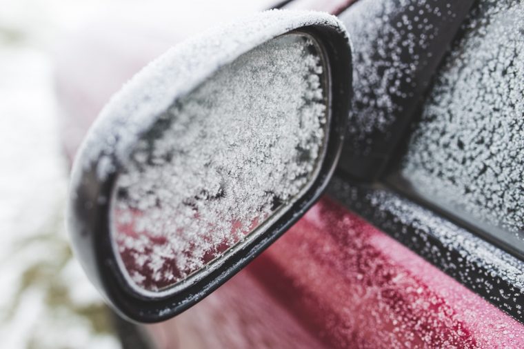 car external mirror covered in frost