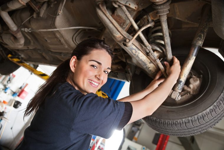 female mechanic working on a car 