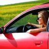 Young woman in red car