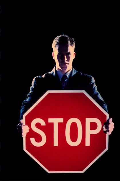 Guy holding Stop Sign