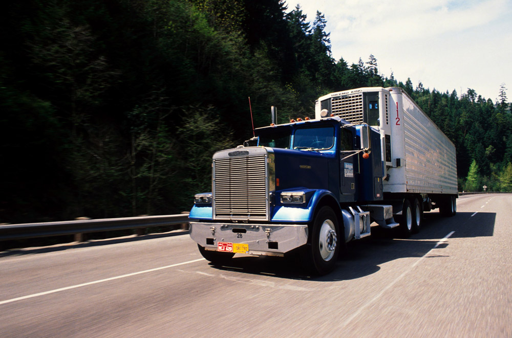 Semi-truck big rig on the highway being driven by truck driver as a career