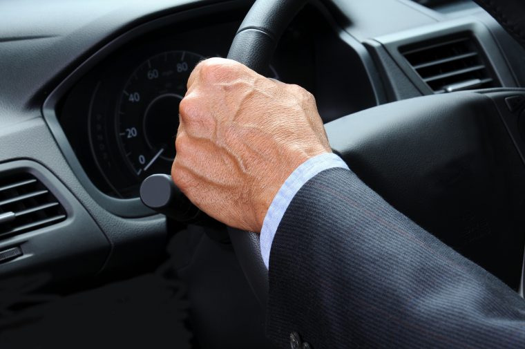 Hands tight on steering wheel