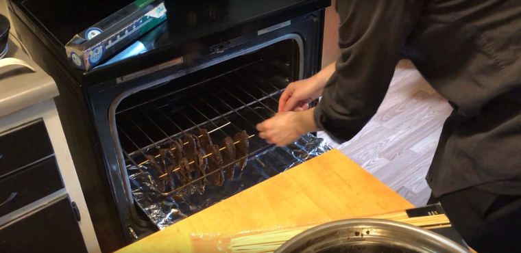 Putting the jerky meat in the oven