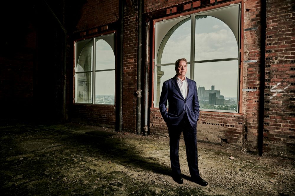 An artistic photograph of Ford Executive Chair Bill Ford standing by a window in Michigan Central Station | Ford Adopts Gender-Neutral Language, Names New Chief Policy Officer