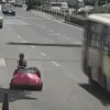 Woman in Bumper Car on Road