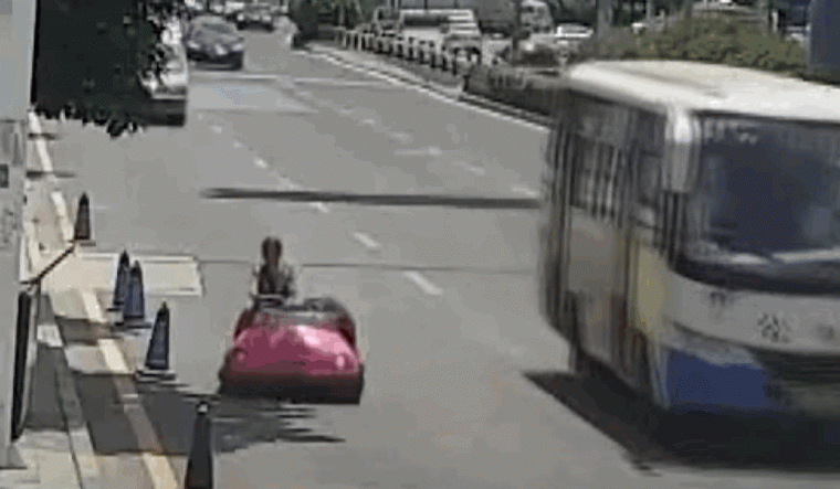 Woman in Bumper Car on Road