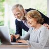 elderly couple shopping browsing online computer laptop at home