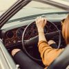 woman driving classic car