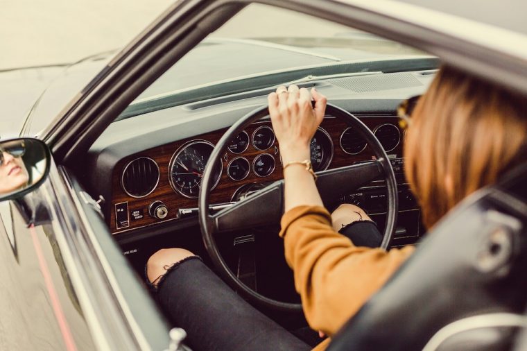 woman driving classic car