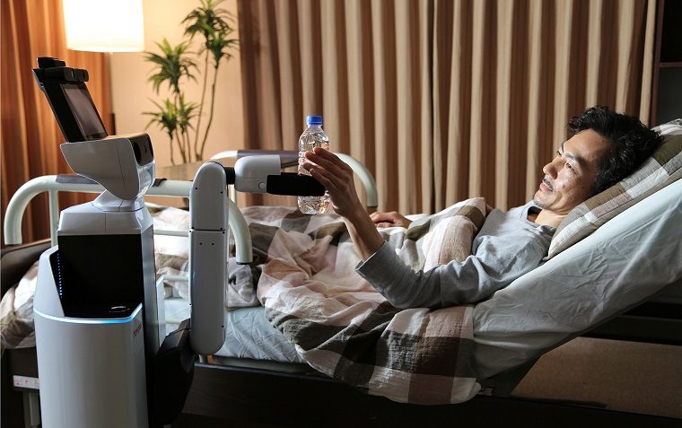 A robot assists a man in taking a water bottle