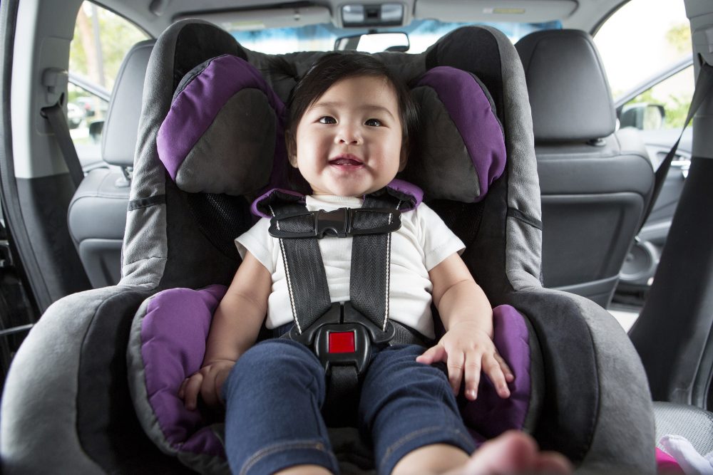 Baby strapped into a Car Seat with a five-point harness