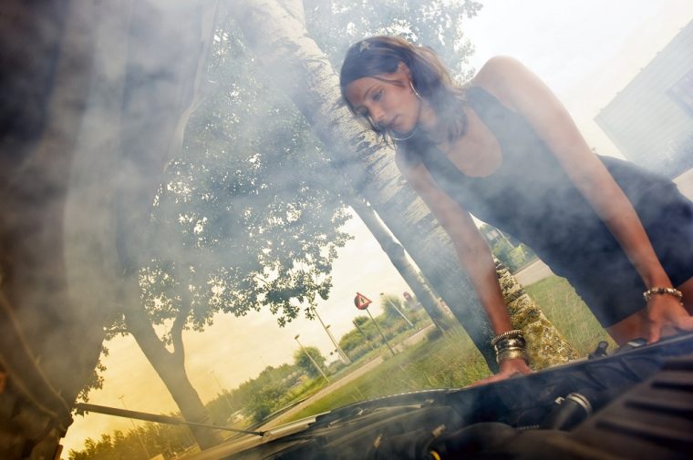 woman checking car engine