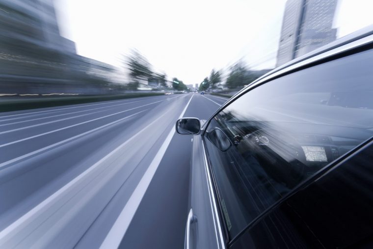 car driving fast on highway