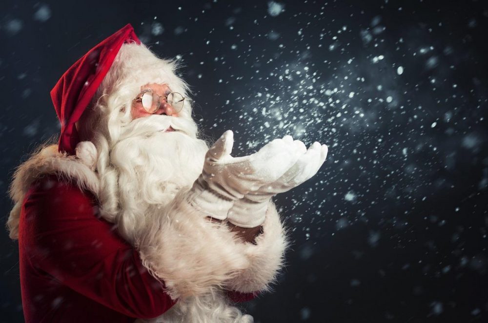 santa blowing snow from his hand