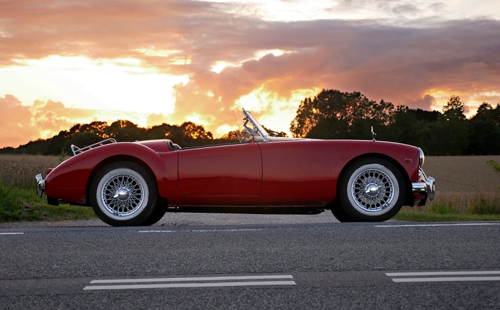 classic red convertible car at sunset