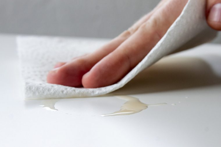 cleaning up a spill with a paper towel