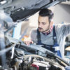 Mechanic inspecting a car under the hood