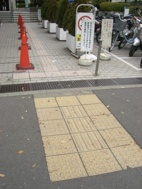 Seiichi Miyake Tenji bricks bumpy pavement tiles in japan crosswalk intersection