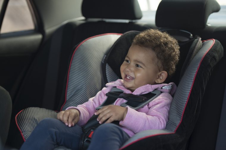 smiling kid in car seat