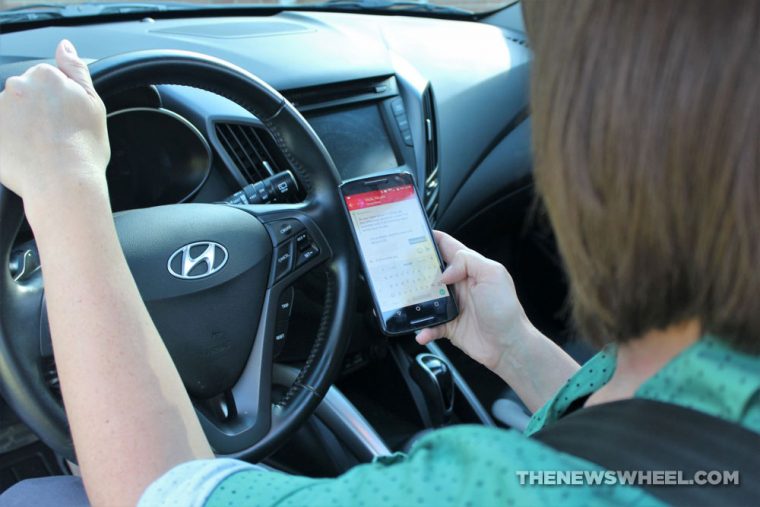 female driver texting while behind the wheel