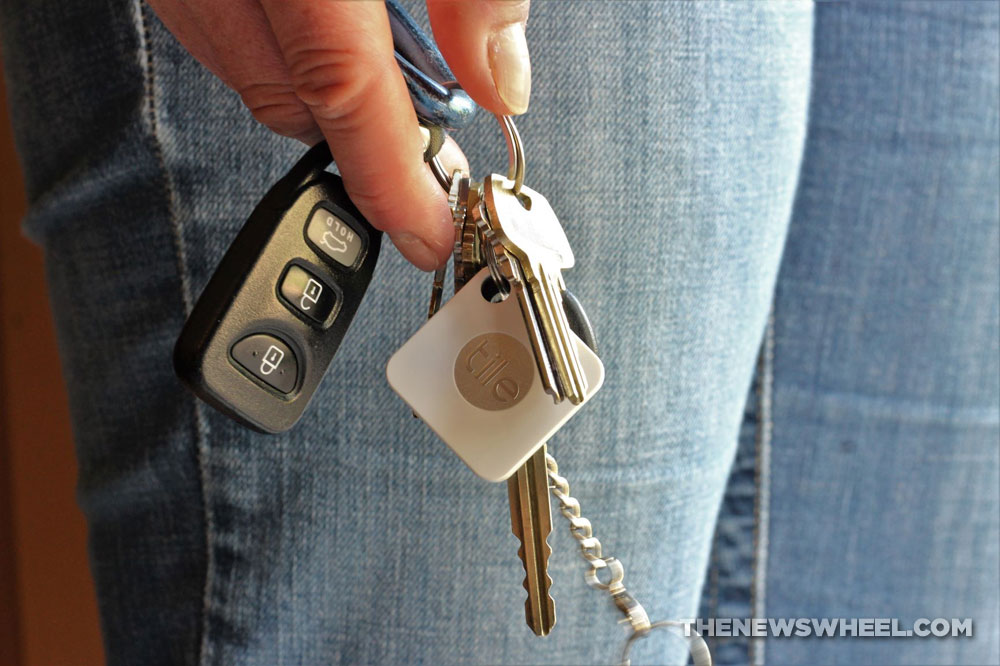 Person holding car keys to a new car when considering resale value