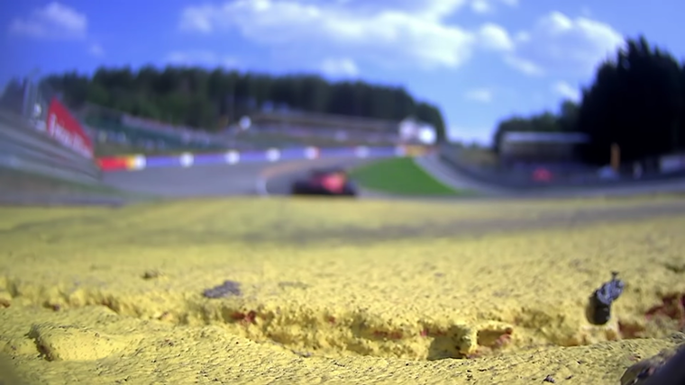 Charles Leclerc racing through Eau Rouge