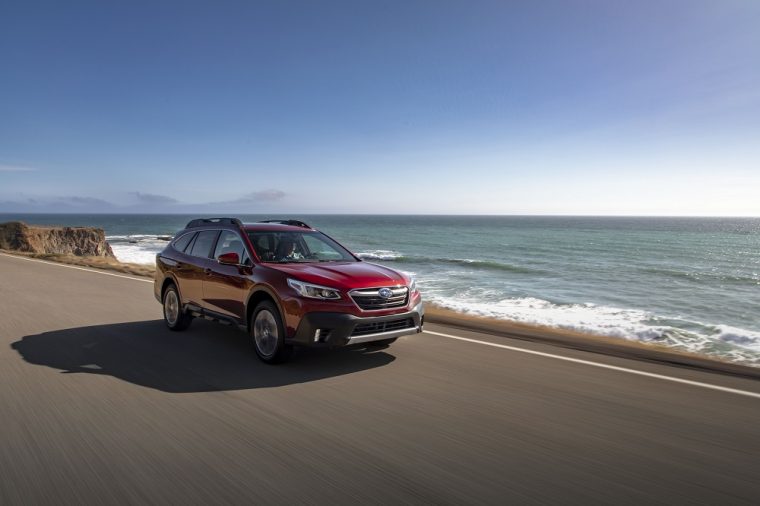 A red 2020 Subaru Outback on a scenic highway