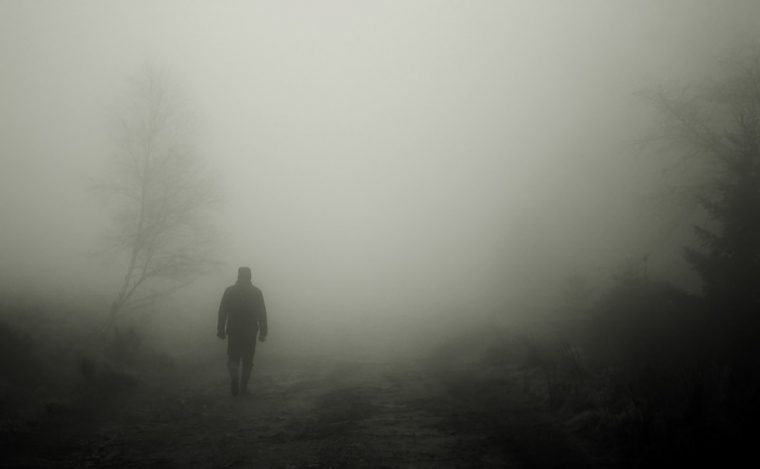 man walking in fog haunted spooky halloween