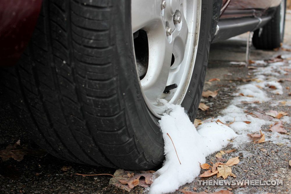 Snow on tires cold temperatures winter freeze chill melting ice wheels